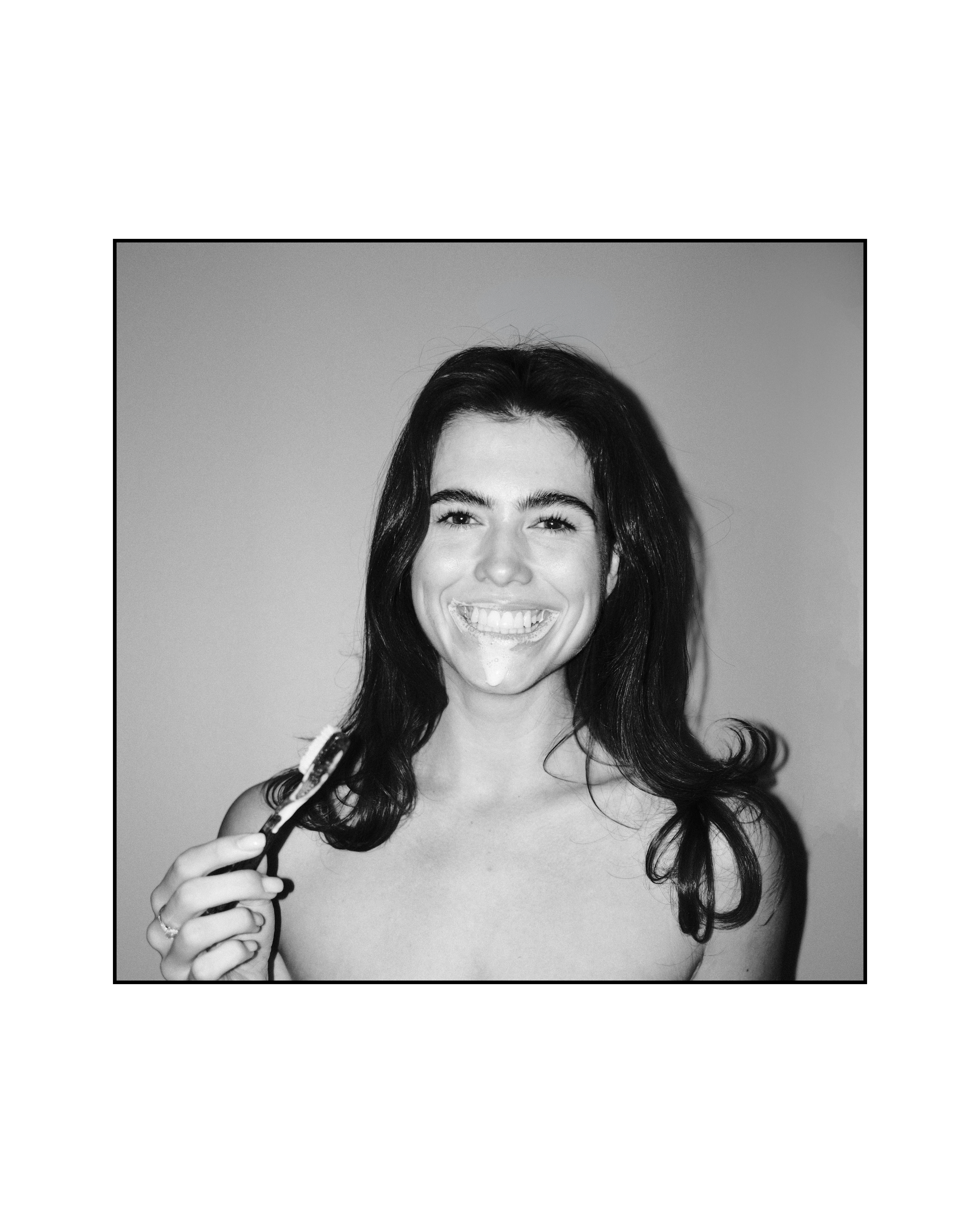 Woman smiling with Natuoral fluoride-free hydroxyapatite toothpaste — natural whitening oral care