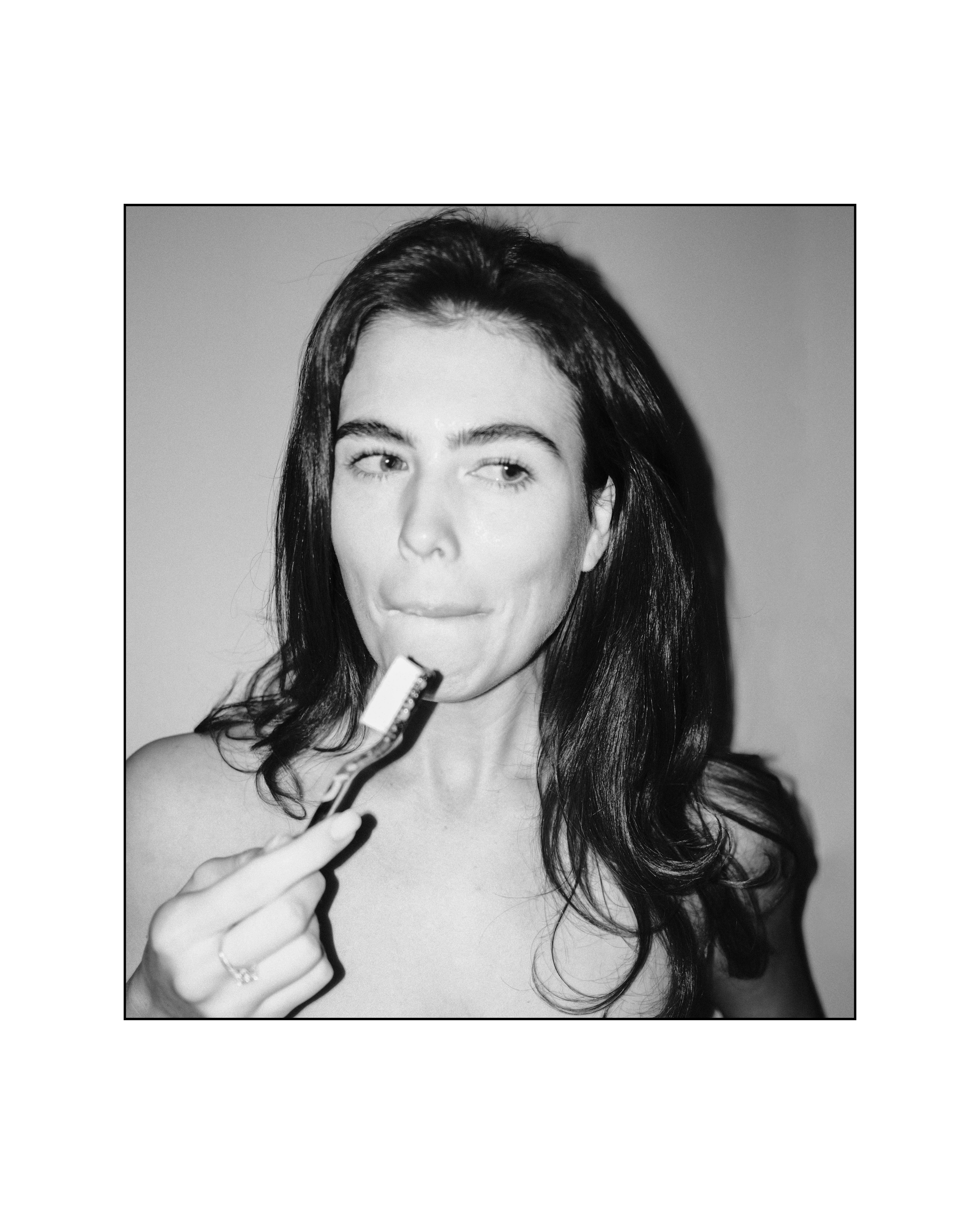 Woman using Natuoral natural toothbrush with fluoride-free hydroxyapatite toothpaste